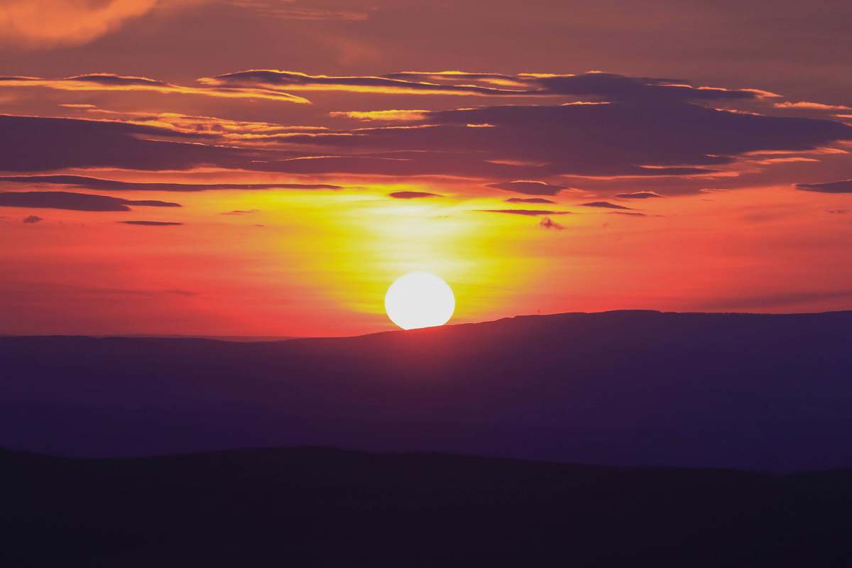 sky silhouette of mountain under golden hour sunset