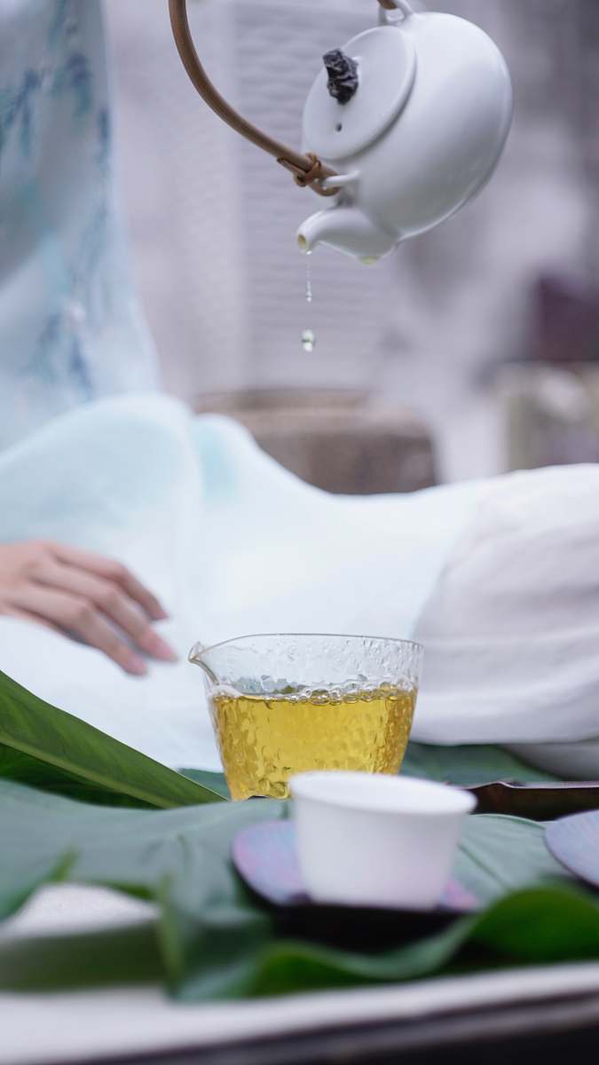 china person pouring tea on glass cup guangzhou