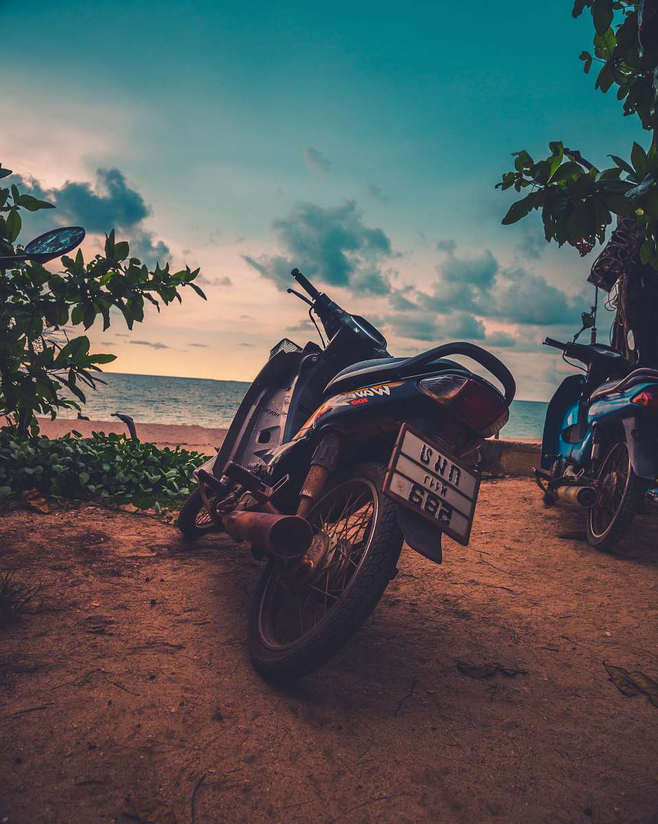 motorcycle two black motorcycles near ocean wheel
