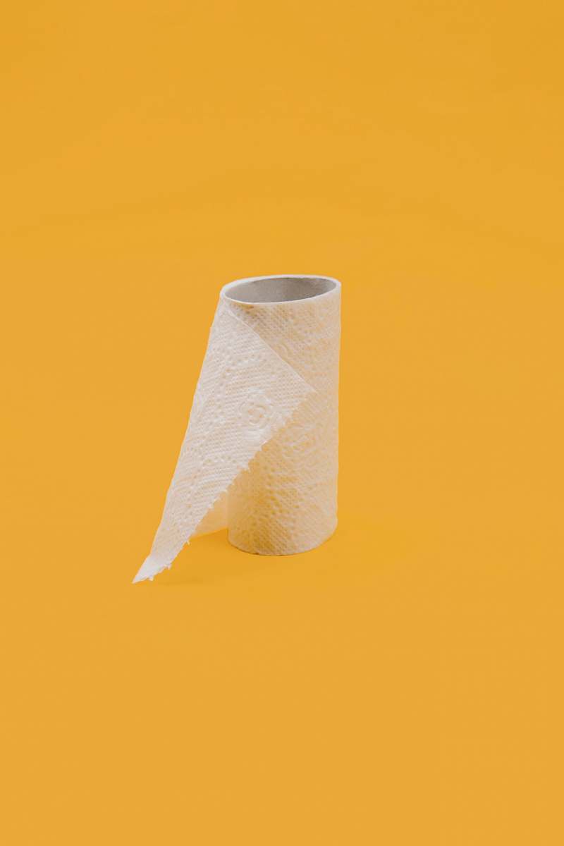 pandemic white tissue paper roll on yellow surface quarantine