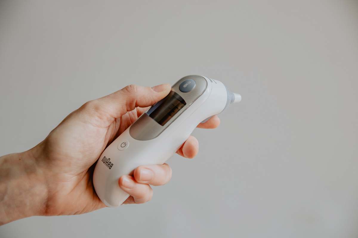 human person holding white and gray electronic device health