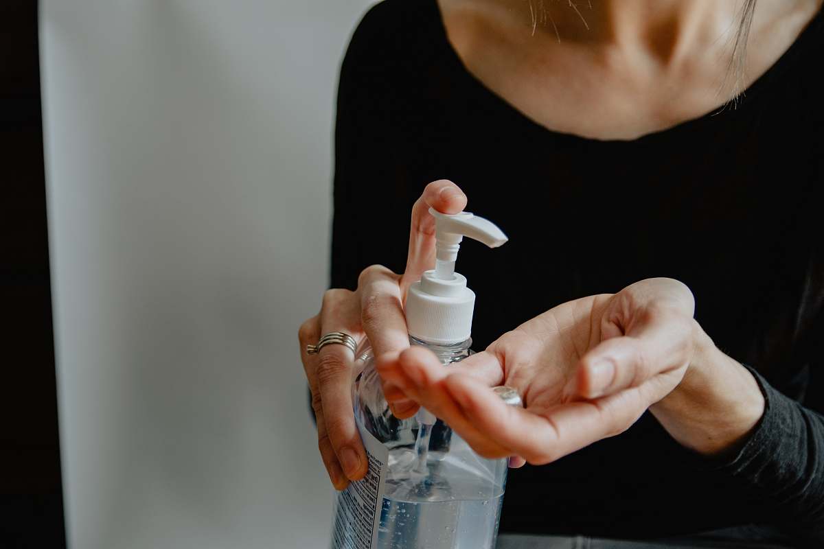 human woman in black shirt holding white plastic bottle health
