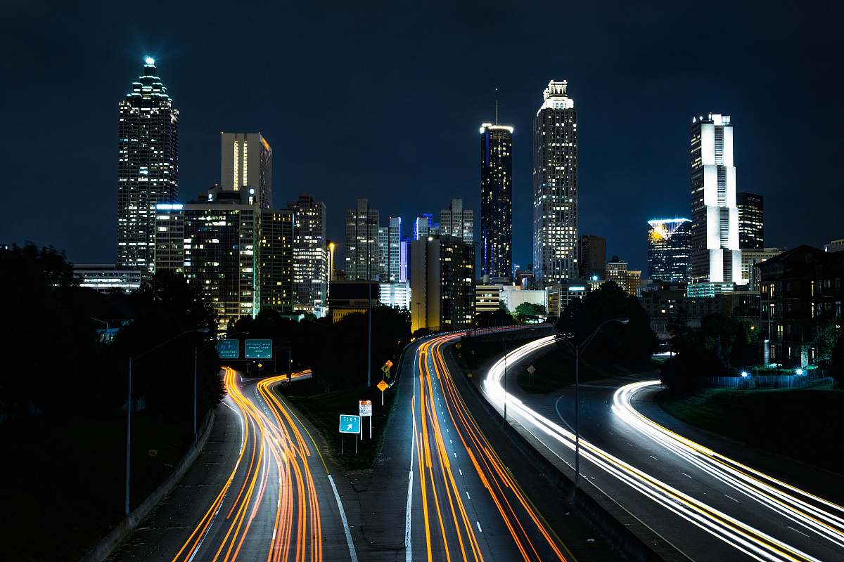 building time lapse photo of passing cars during night time night