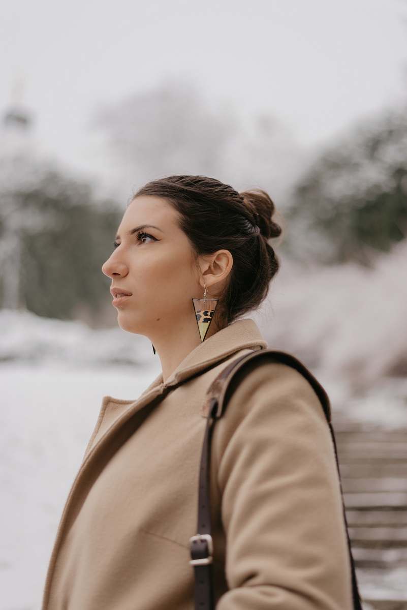  selective focus photography of woman in brown coat 
