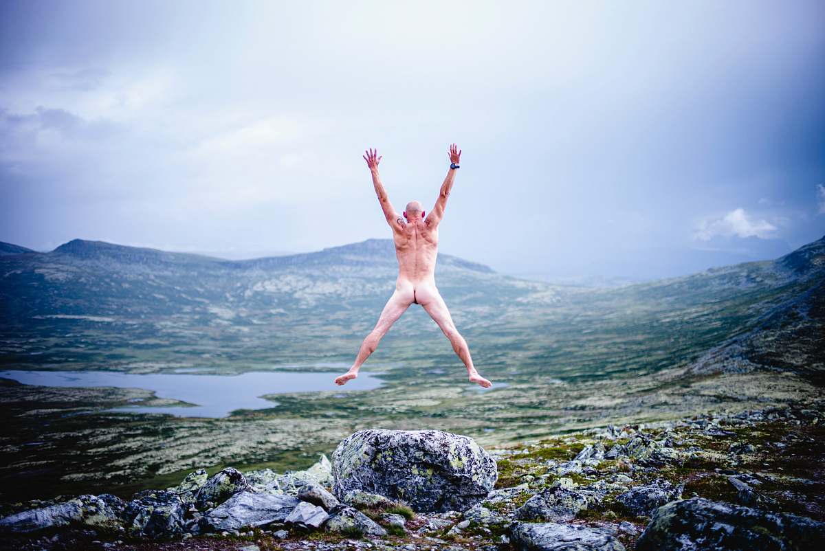 person woman in white bikini lying on rock near body of water during daytime dance pose