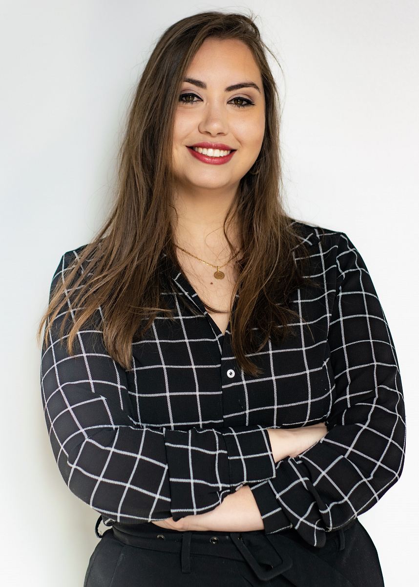 a woman in a black and white shirt and black pants