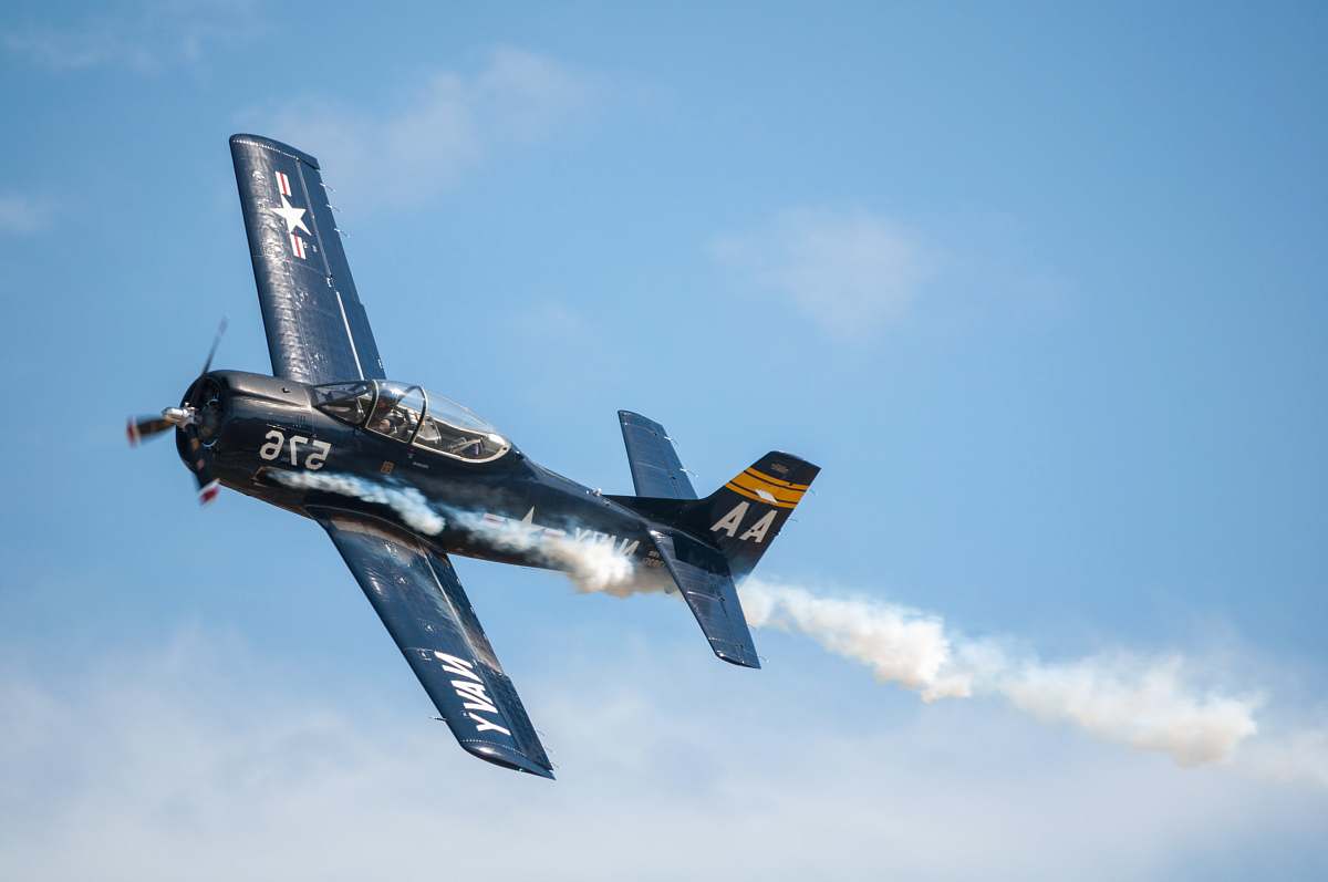 airplane black biplane doing aerobatics transportation