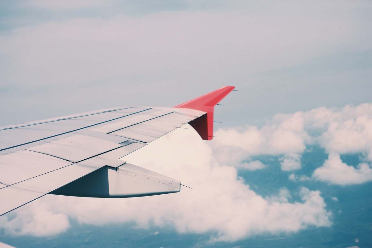 aircraft flying airplane surrounded by clouds transportation