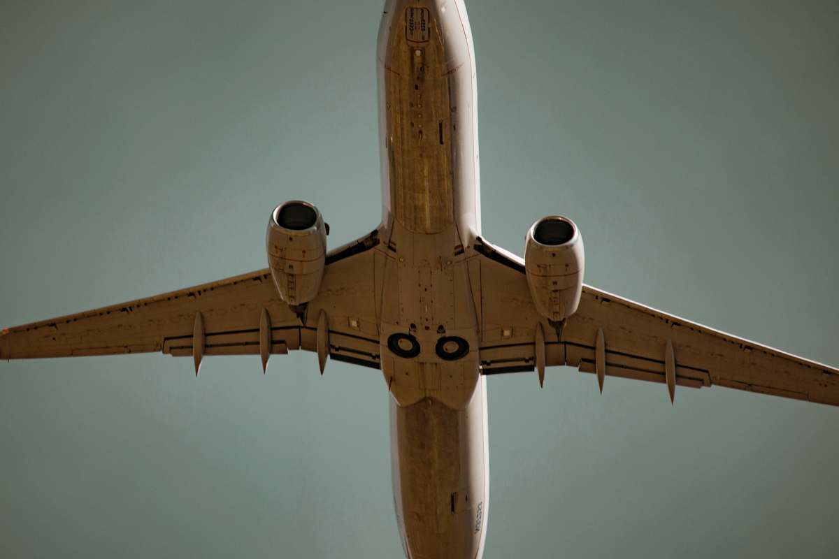 plane low angle photography of white airliner sky