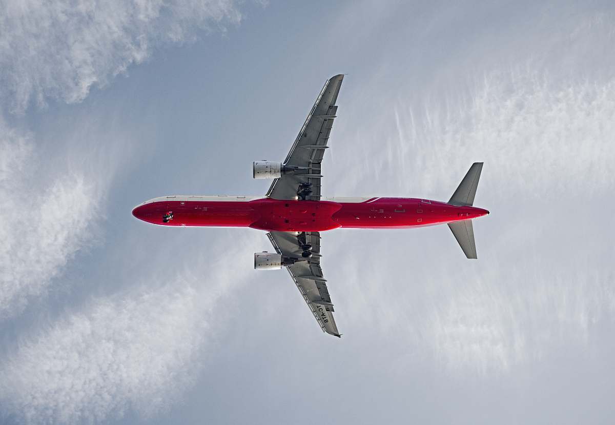 transportation red and white passenger airplane on the sky during daytime aircraft