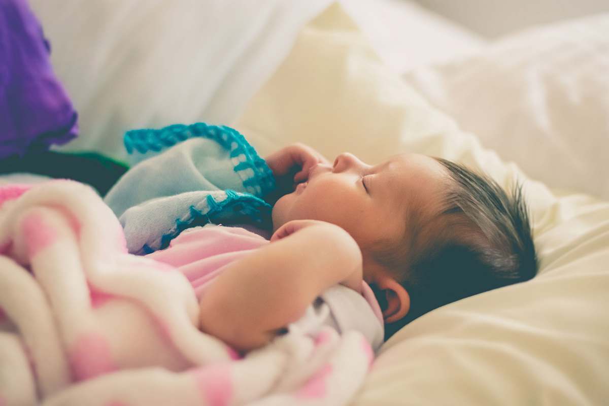 human baby sleeping on bed person