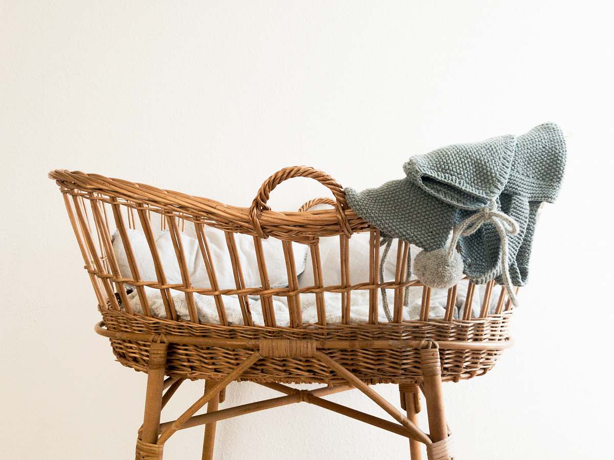 cradle gray textile hanging on brown wicker basket furniture