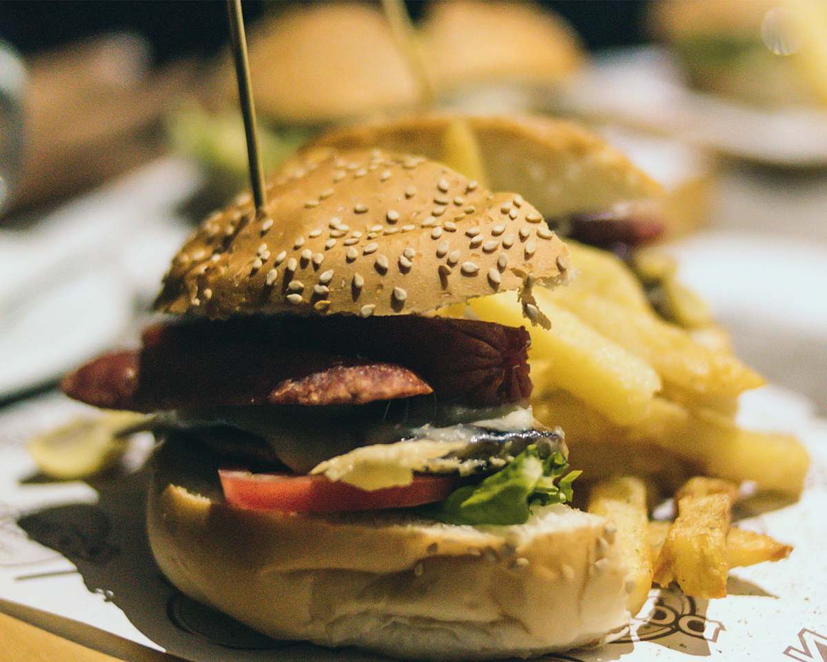 food hamburgers with bites on white tray bread