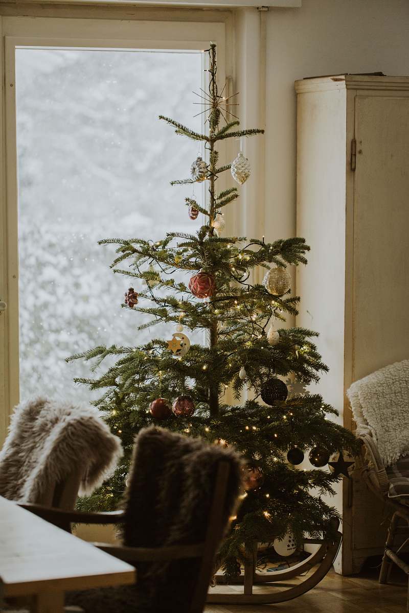 ornament green Christmas tree with assorted-color baubles inside room vase