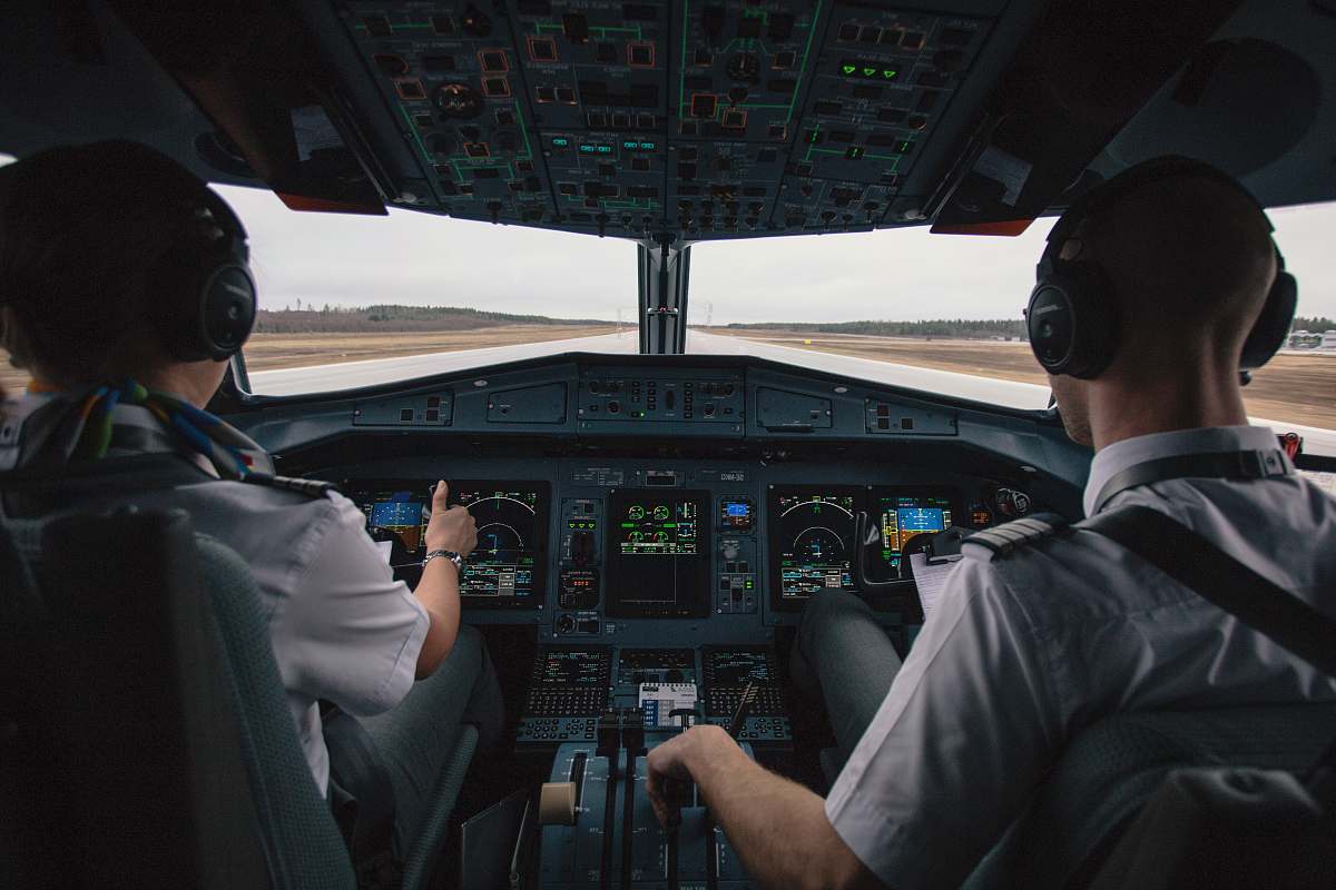 people two men driving plane at daytime human
