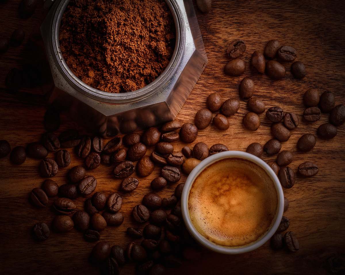 food brown coffee beans beside white ceramic mug flora