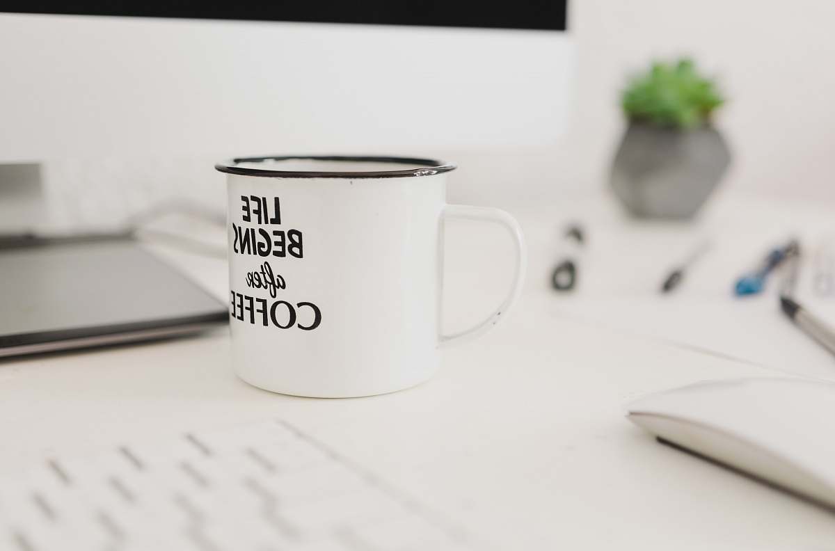 cup selective focus photo of white mug near wireless mouse grey
