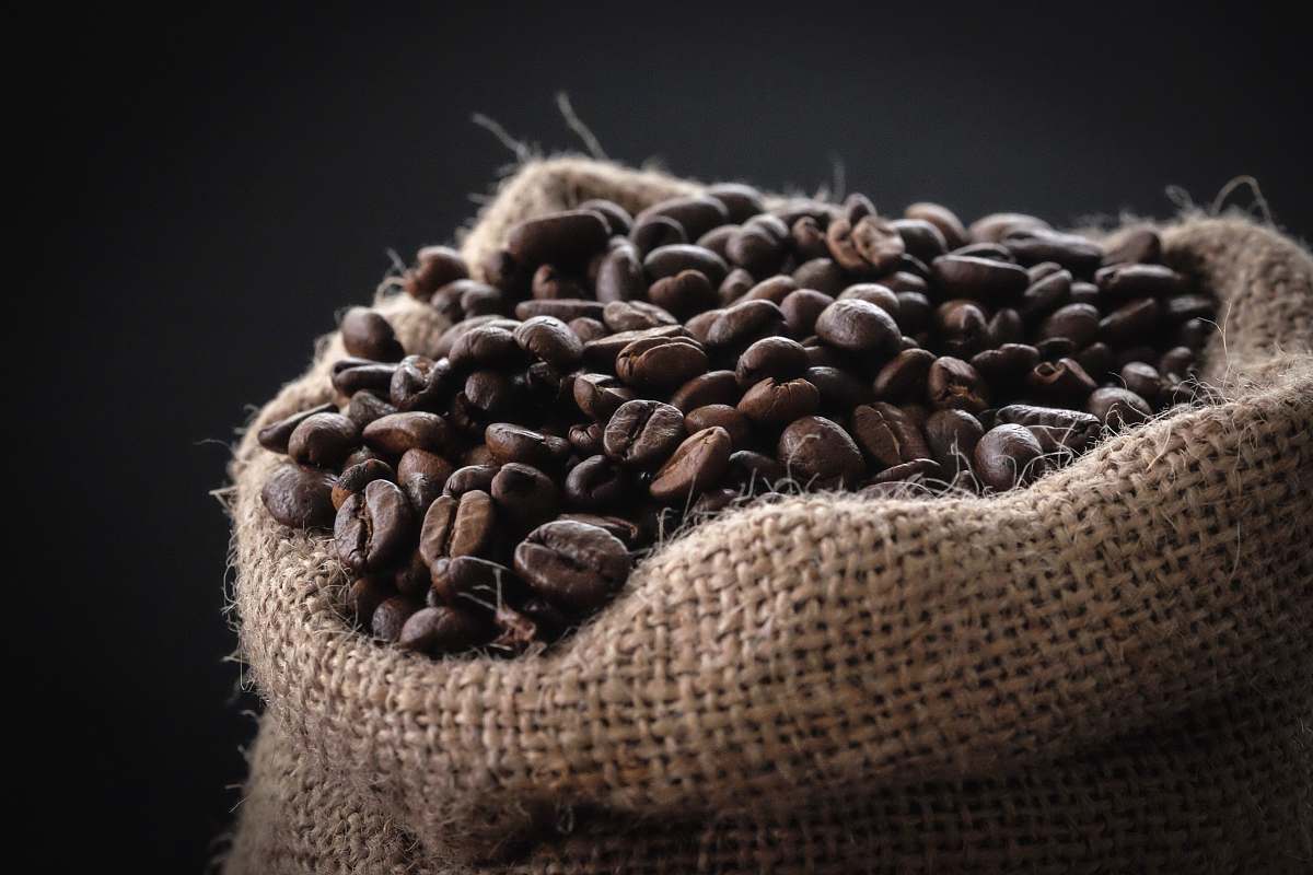 bean shallow focus photography of coffee beans in sack food