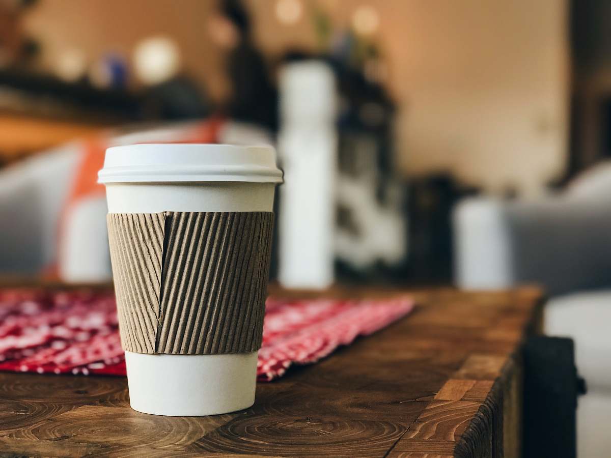 coffee white plastic cup on brown surface disposable