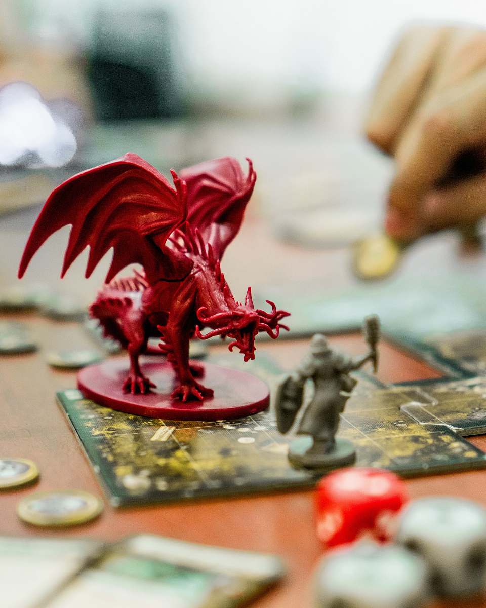 human red dragon action figure on table person