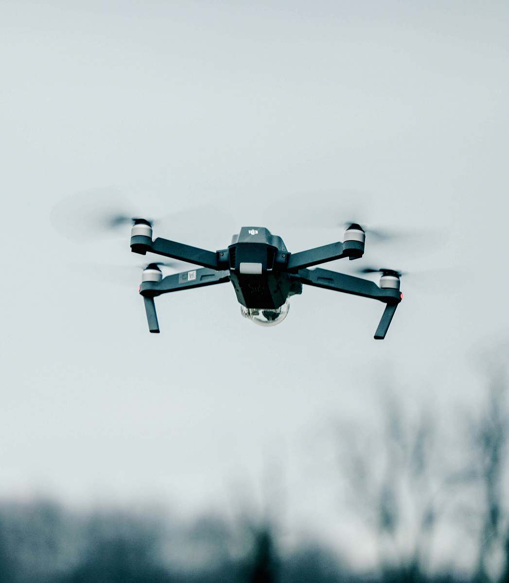 fly selective focus photography of flying quadcopter equipment