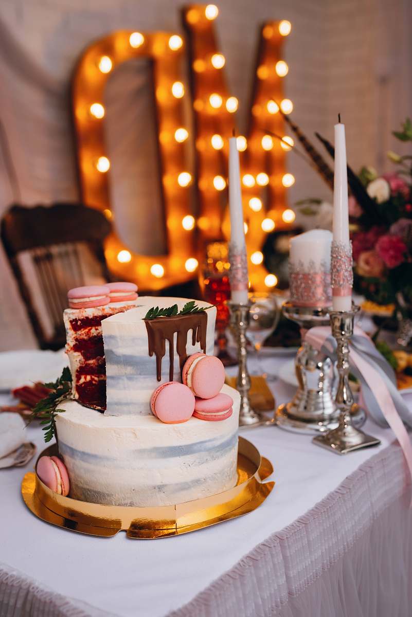 cake 2-tier cake on table beside candles dessert