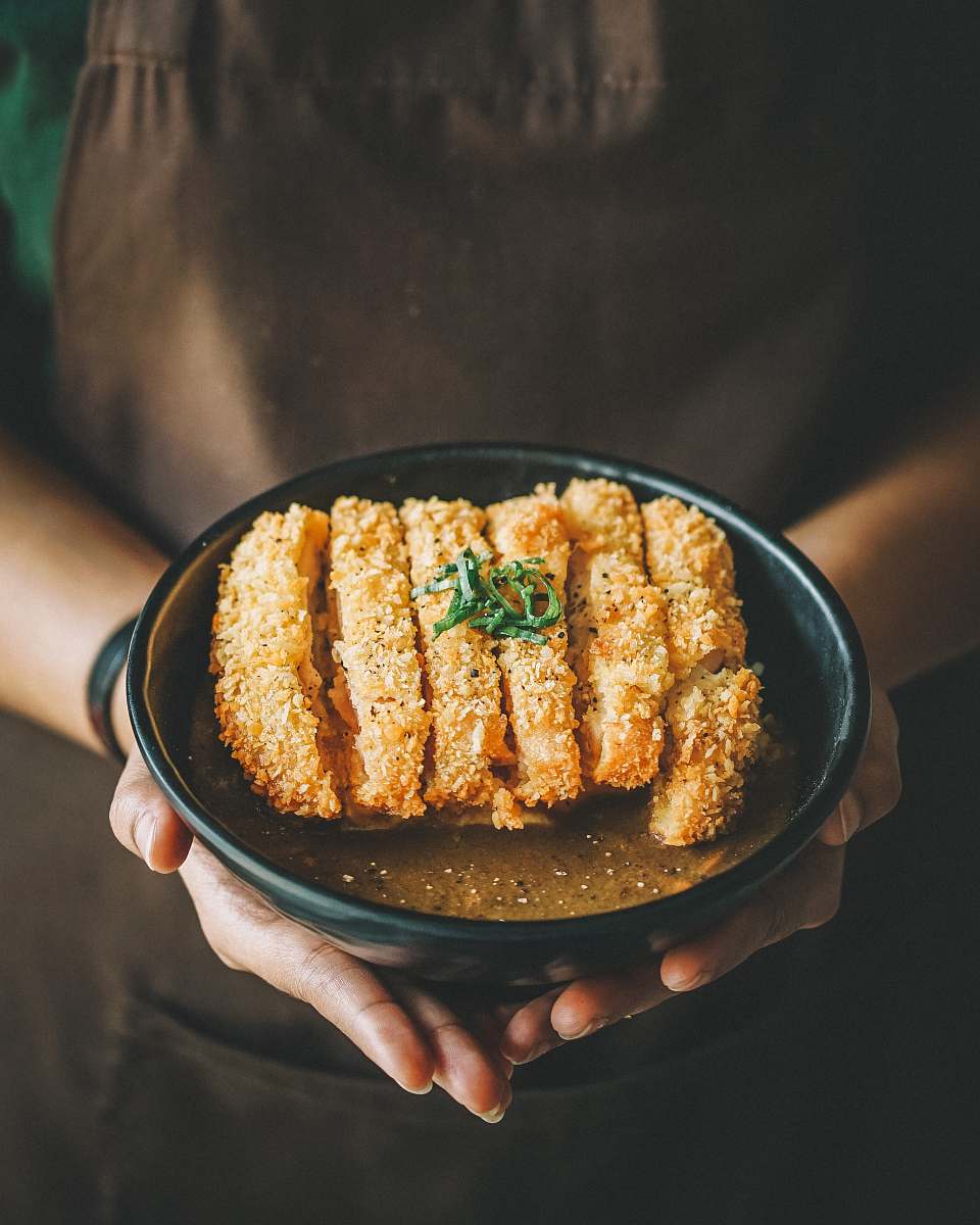 seasoning fried dish on round black plate sesame