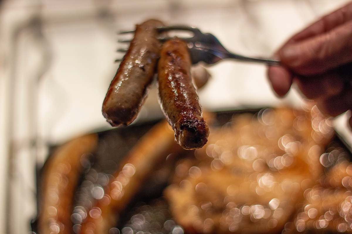 animal two grilled sausages on a fork lobster