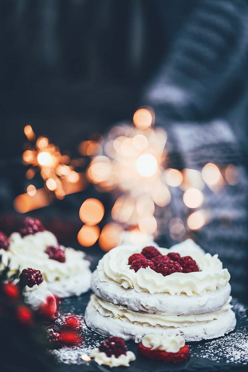 cake white icing-covered cake on black surface cream
