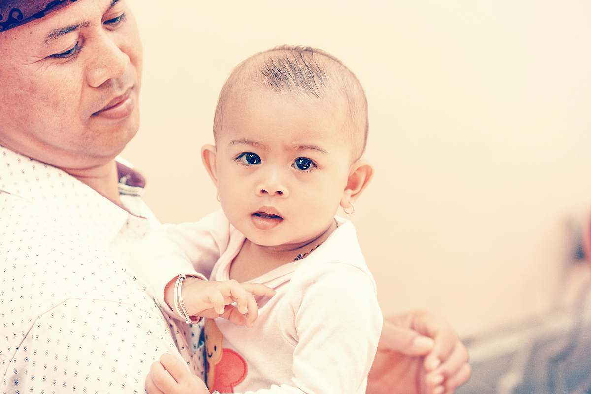 person man holding baby baby