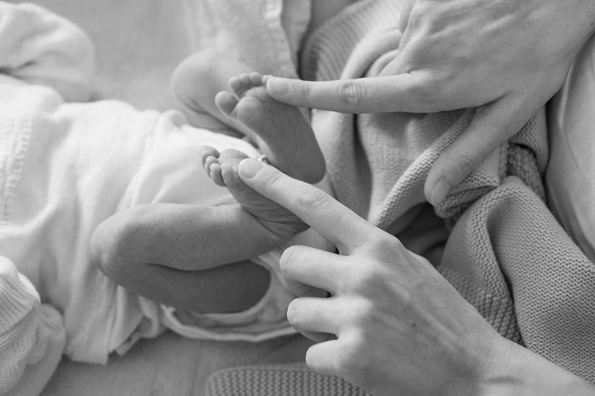 baby person holding baby's feet black-and-white