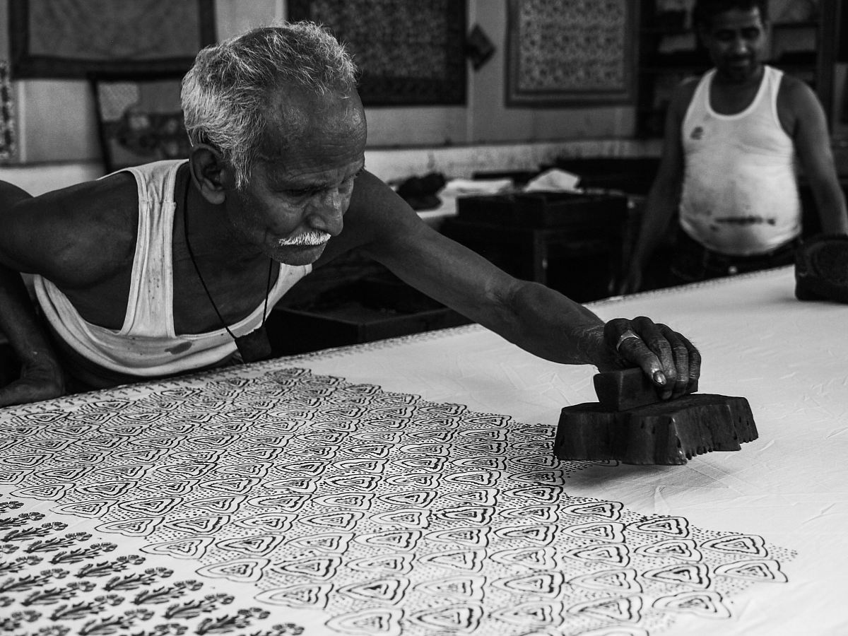 man stamping on white surface grayscale photography
