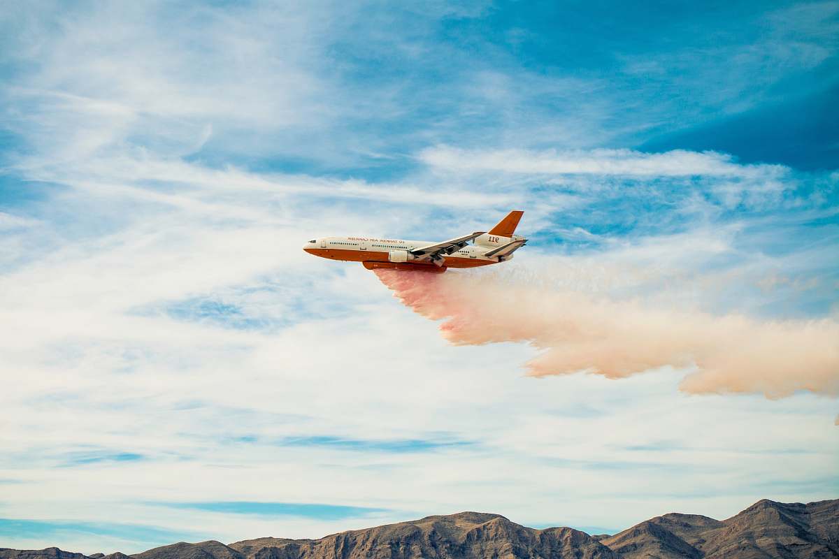flight white plane spreading pink smoke airplane