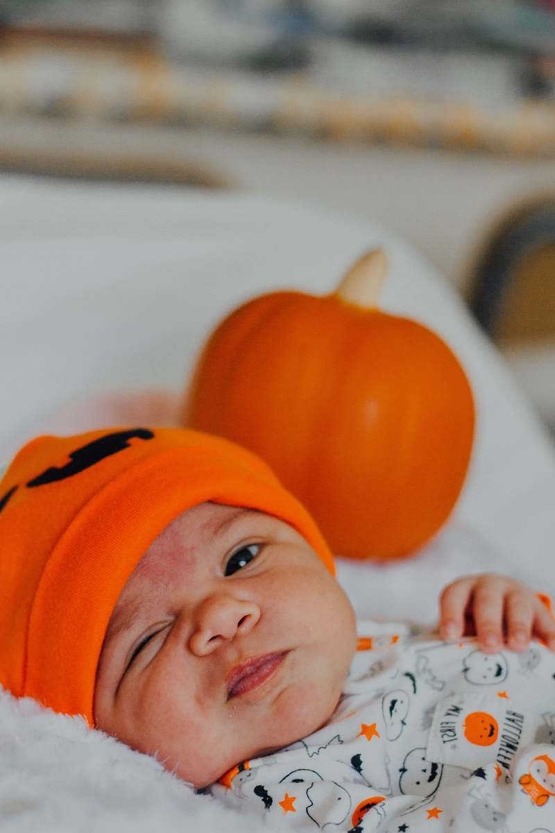 person baby wearing orange knit cap human