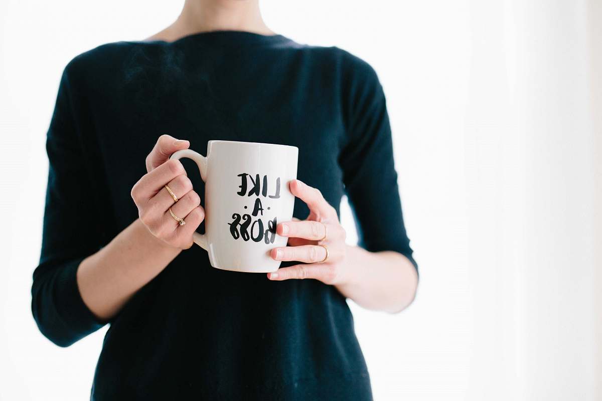 cup woman holding white mug while standing woman