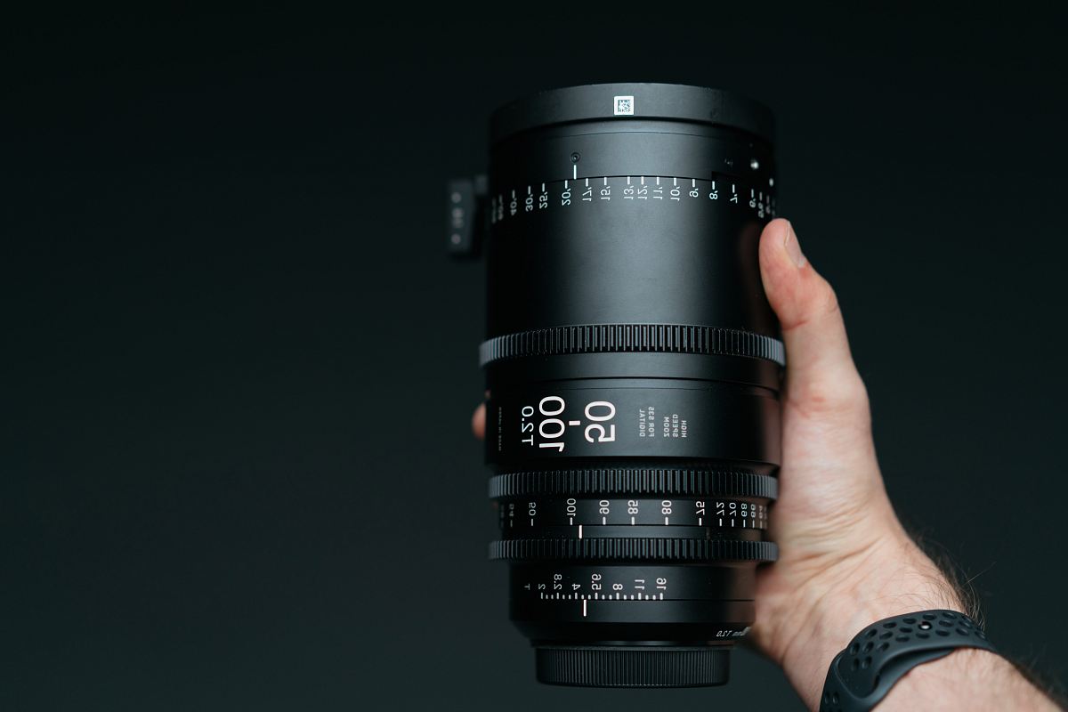 person holding 50-100 mm T2.0 camera zoom lens