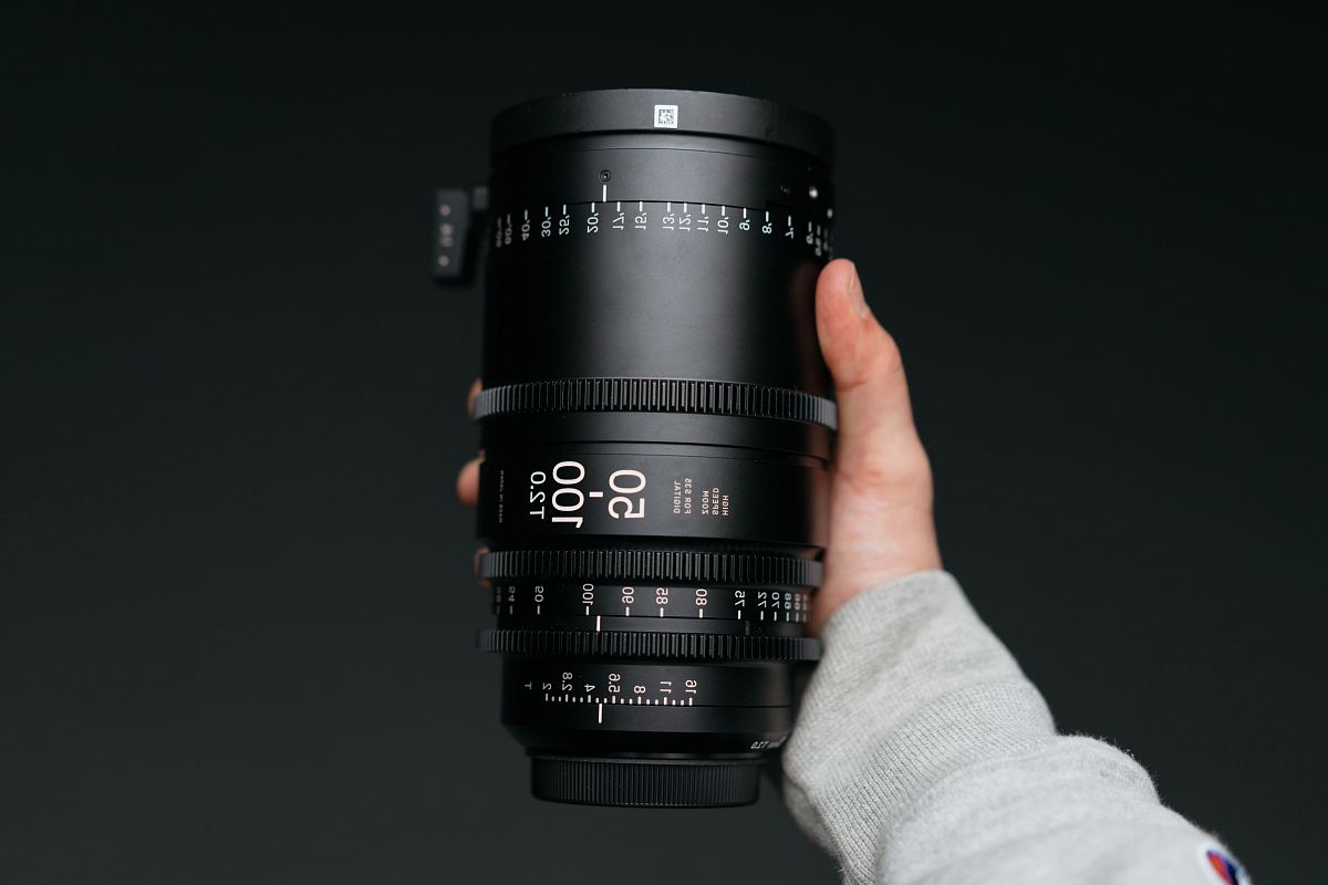 person holding black camera lens