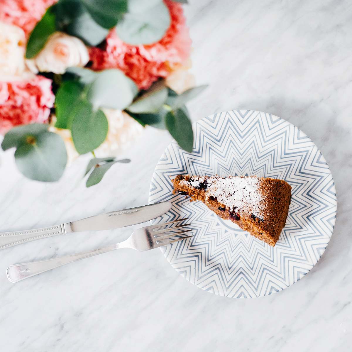 food slice on chocolate cake on plate flower