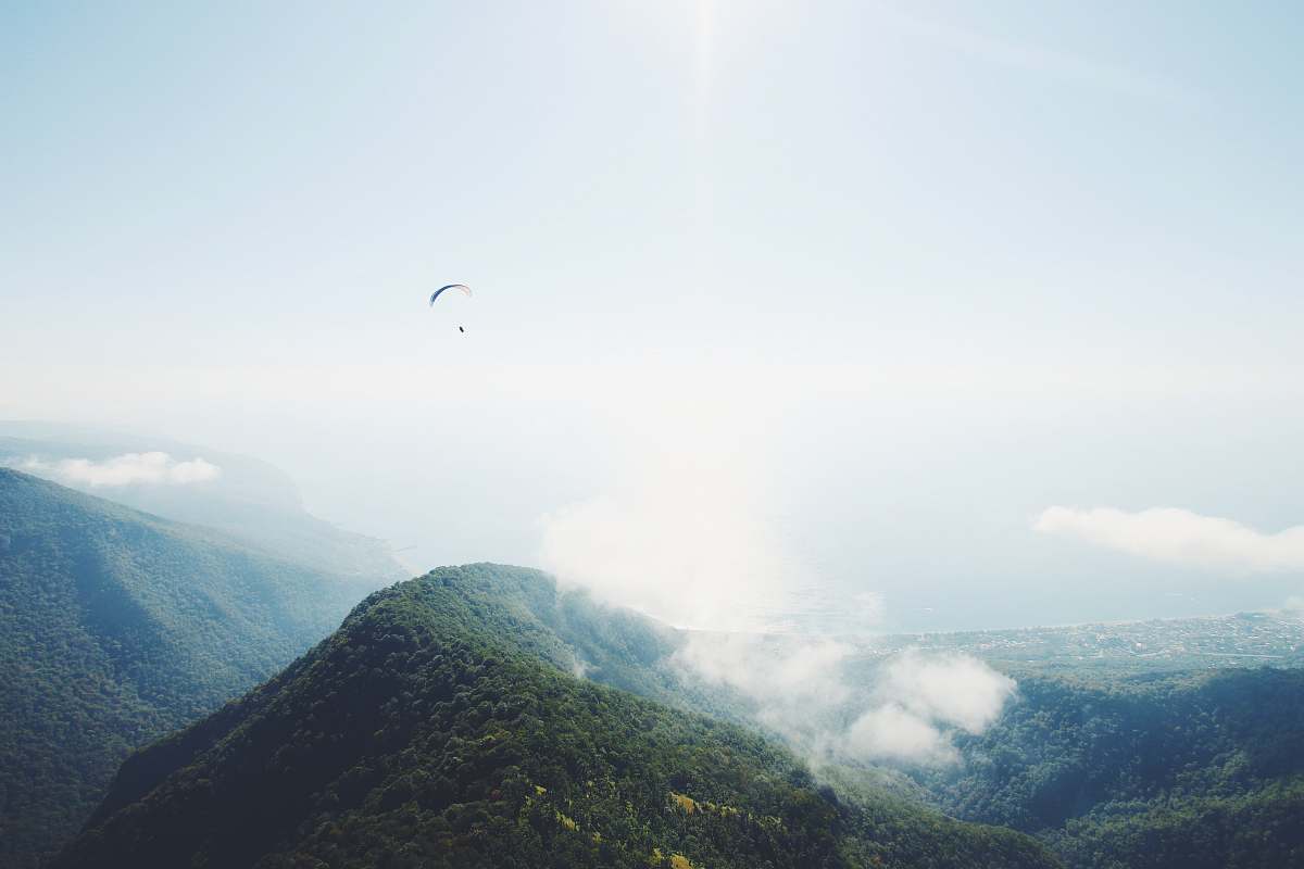 mountain mountain covered by clouds paraglide