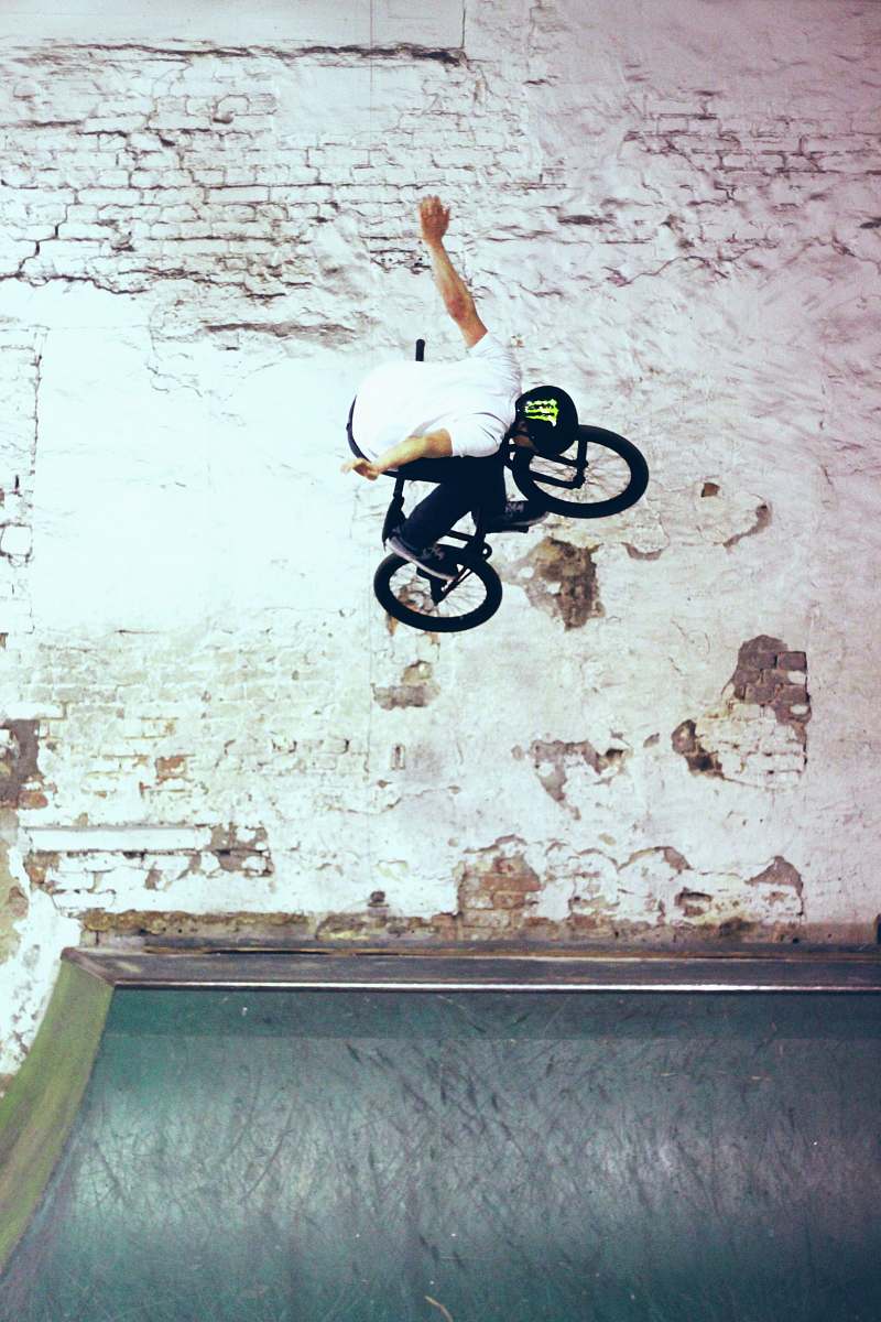 bike man riding black BMX bike doing bike tricks fly