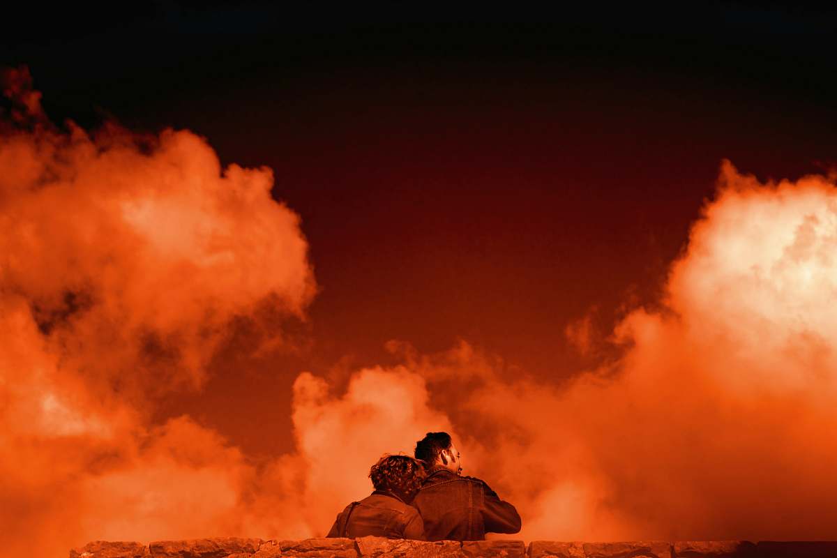 nature man and woman sitting on bench outdoors