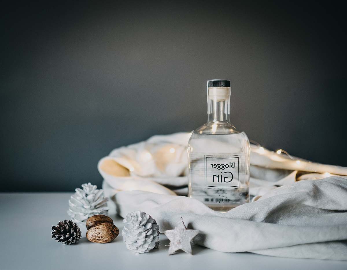 drink Blogger Gin glass bottle on white wooden table gin