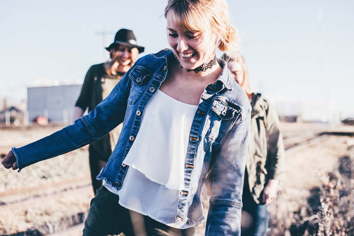 pants girl smiling wearing blue denim button-up jacket standing outdoor during daytime clothing