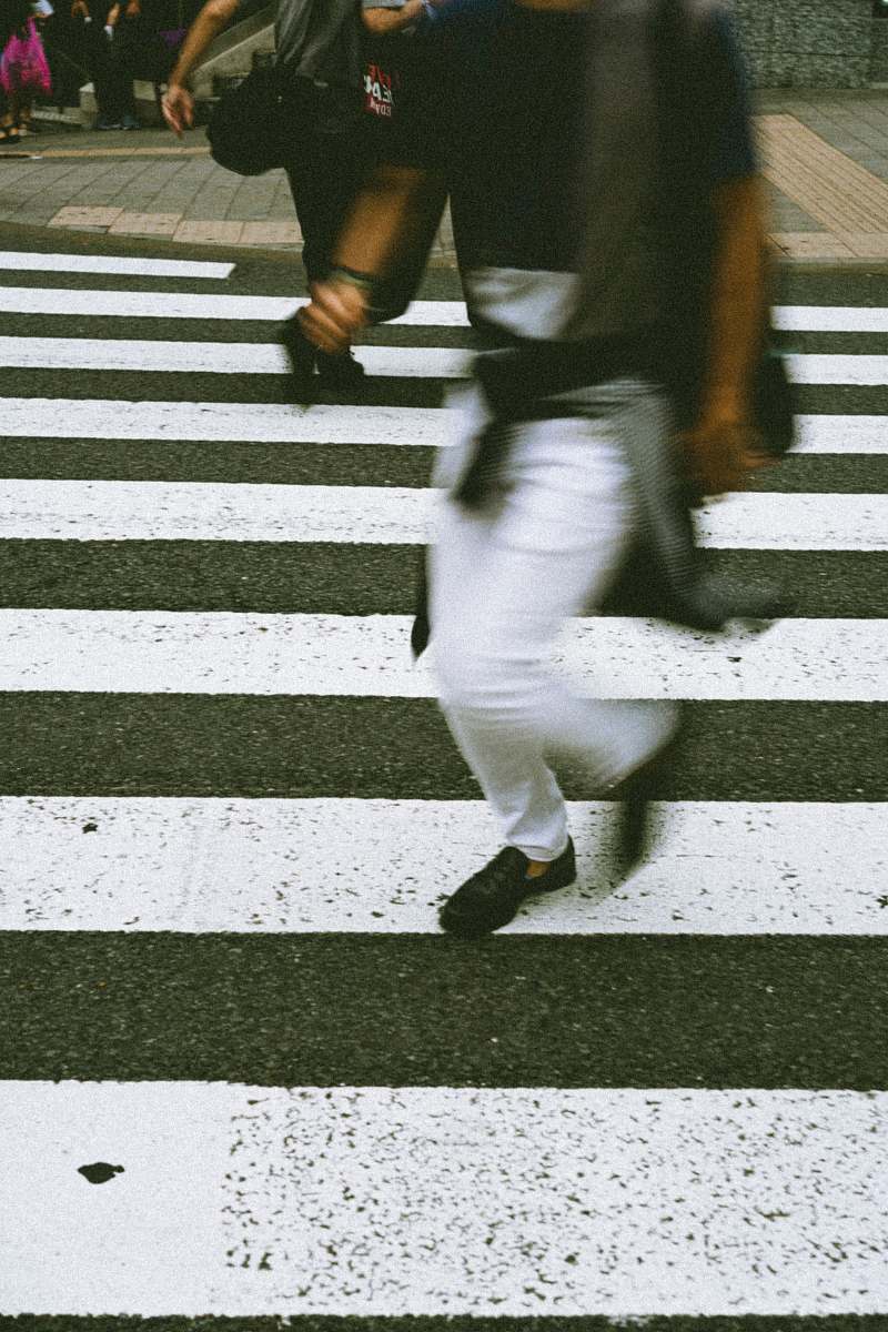 tarmac two person crossing on pedestrian lane road