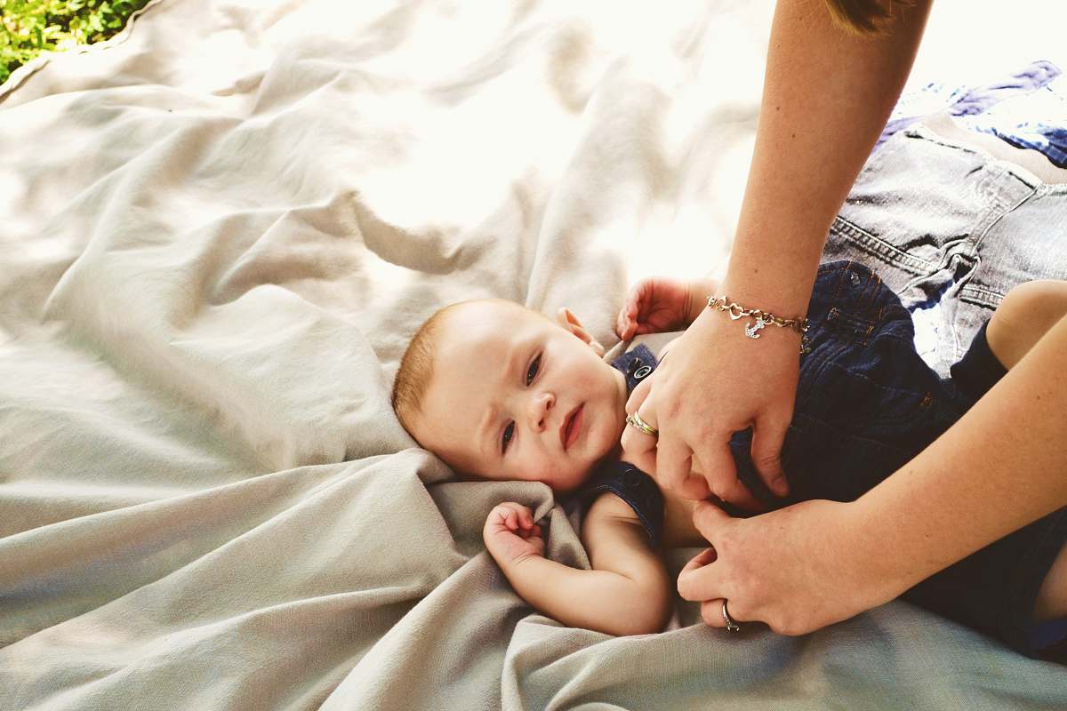 overall baby laying onesie changing