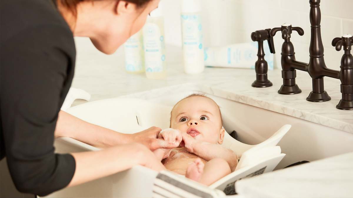 human baby lying on the white textile person