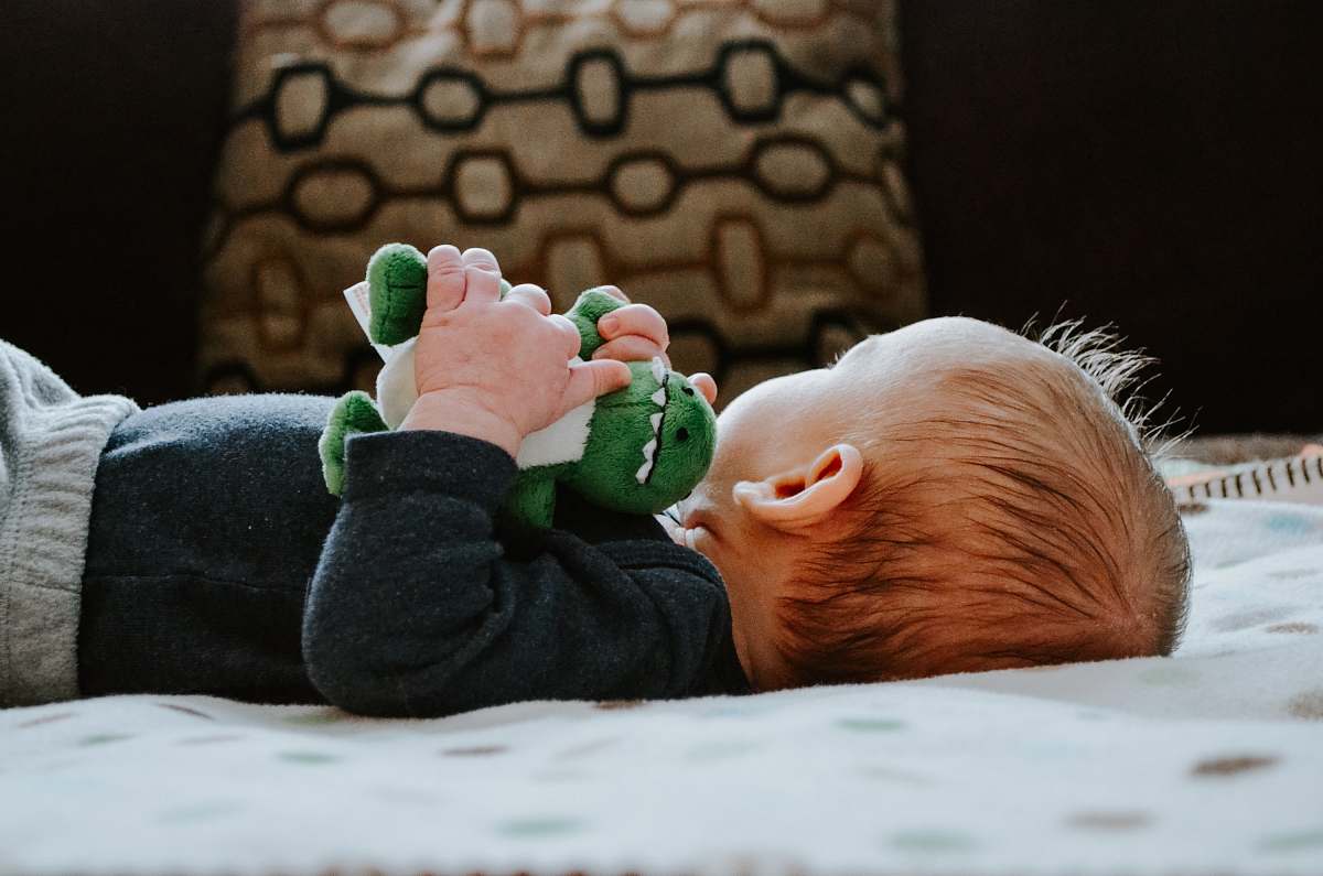 kid baby lying on white bed child