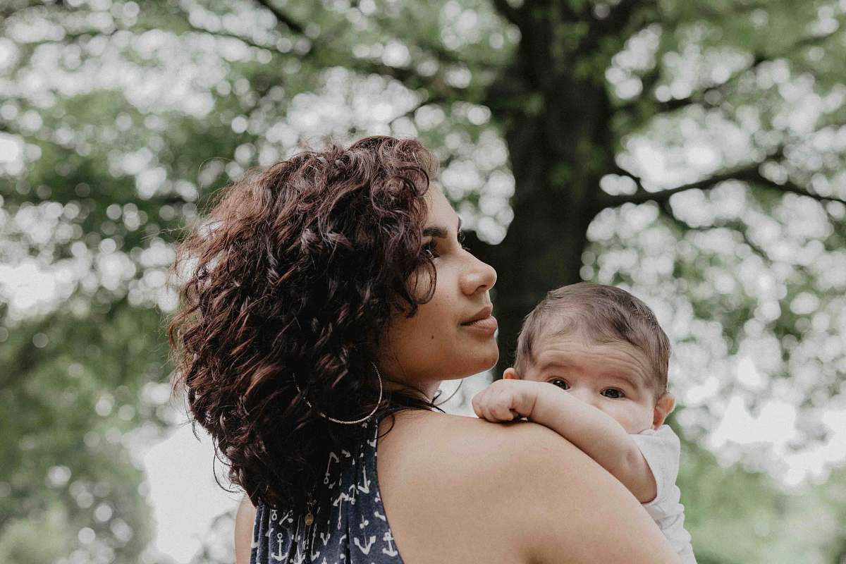 human woman carrying baby person