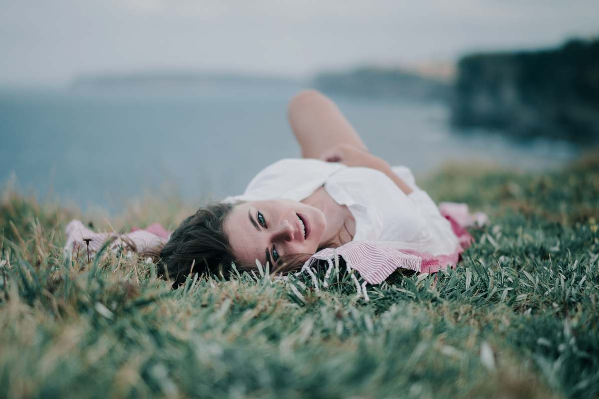 person woman lying on green grass child