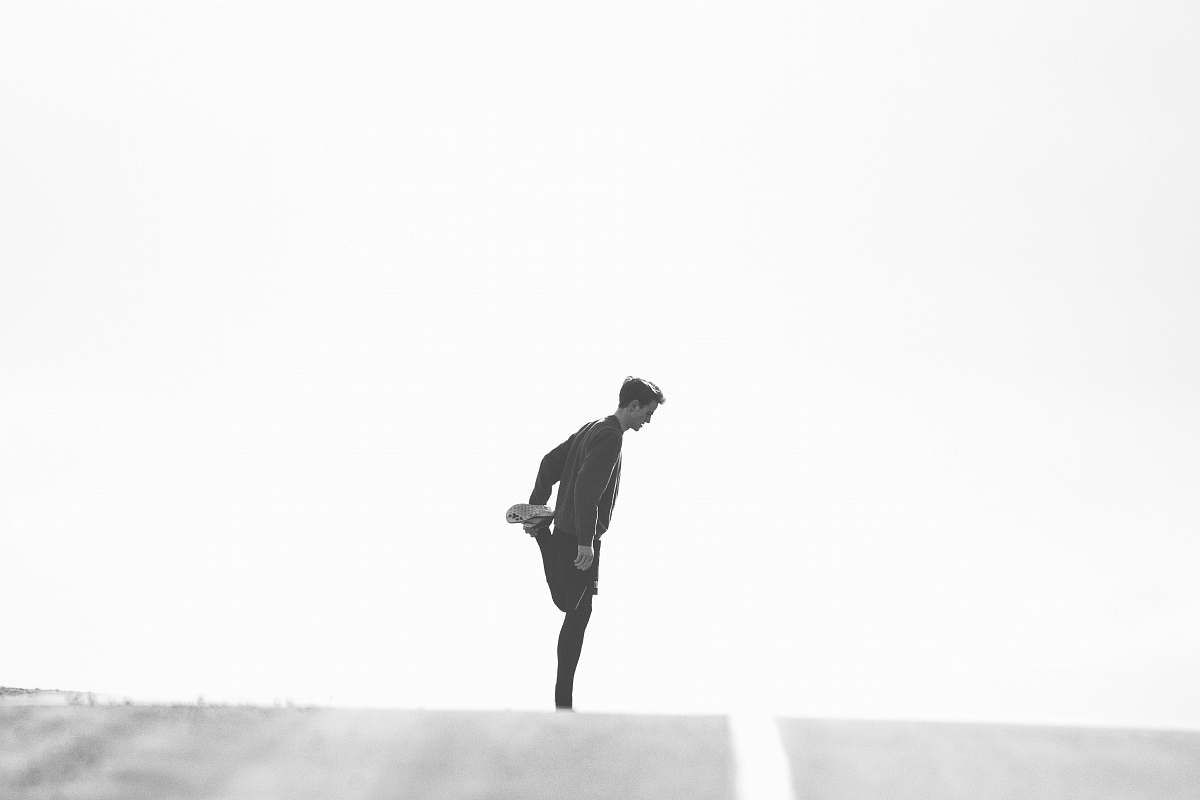 people man wearing black jacket standing on street person